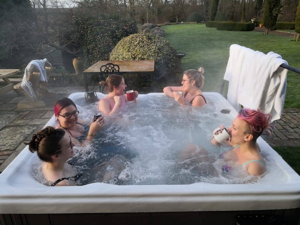 five women in a hot tub in winter